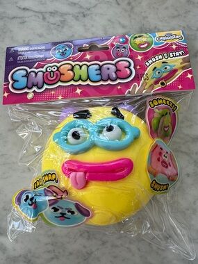 Smushers Yellow Squeezable Face Toy with Blue Mask and Pink Tongue